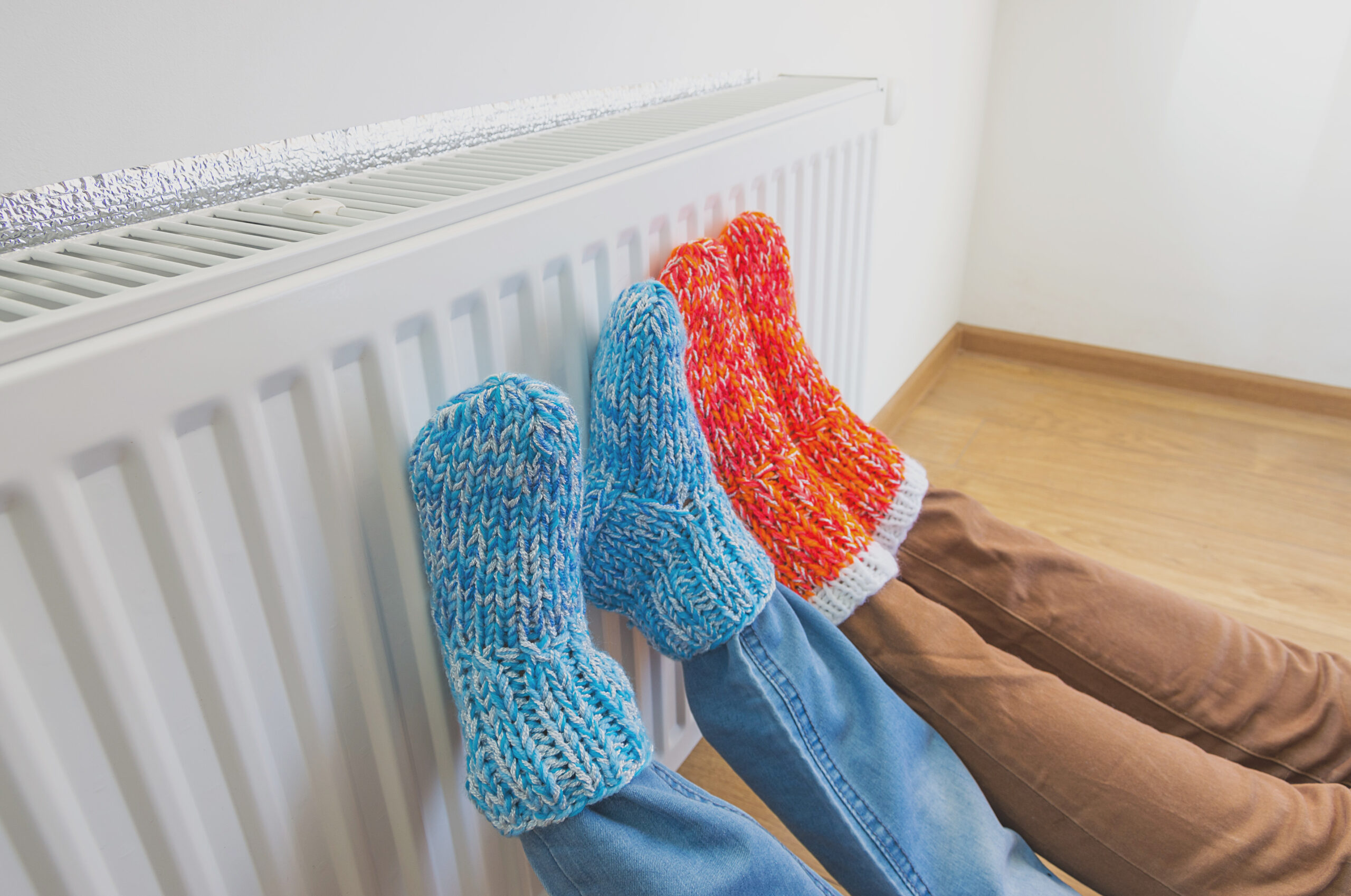 Family,In,Warm,Knitted,Woolen,Socks,Near,A,Home,Heater